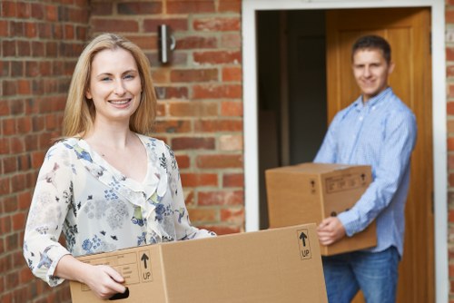 Local movers navigating a narrow Barnes street with furniture