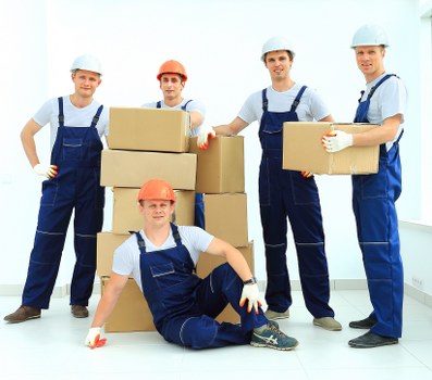 Man and van service loading furniture into a moving vehicle