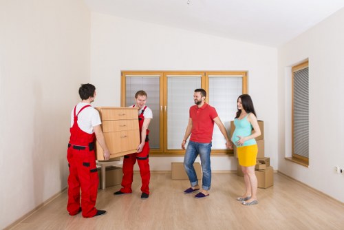 Office movers transporting desks and equipment through a Barnes commercial area