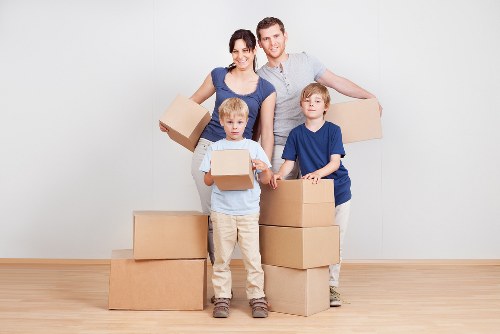 Professional movers using PPE and careful handling for safe transport