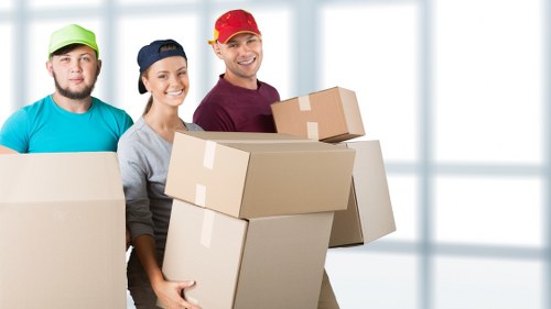 Packed moving boxes and furniture ready for a Barnes home relocation