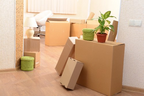 Packed office equipment and furniture ready for removal in Barnes