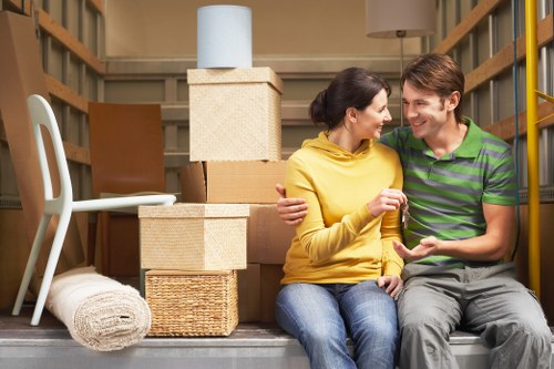 Removal van and moving crew handling furniture in Barnes